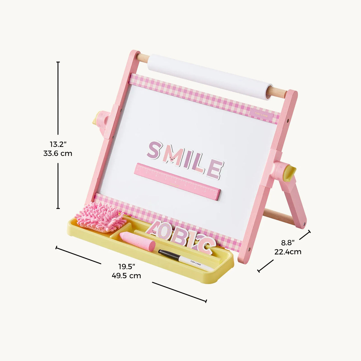 Pink 3-in-1 Adjustable Tabletop Art Easel with a whiteboard, paper roll, and accessory tray, showing dimensions in inches and centimeters.