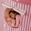 A child sleeps inside a pink-and-white striped Starry Indoor Play Tent for Toddlers, visible through a circular window.