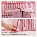 A hand fastens the Velcro tabs on a pink and white striped Starry Indoor Play Tent for Toddlers, which features roll-up curtains tied at the top.