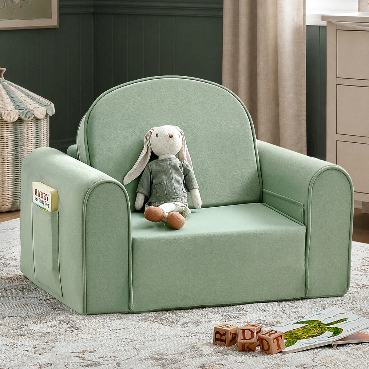 Light green GentleSnug Flip-Open Kids Sofa & Nap Mat with a rabbit plush toy sitting on the seat and a book stored in the side pocket.
