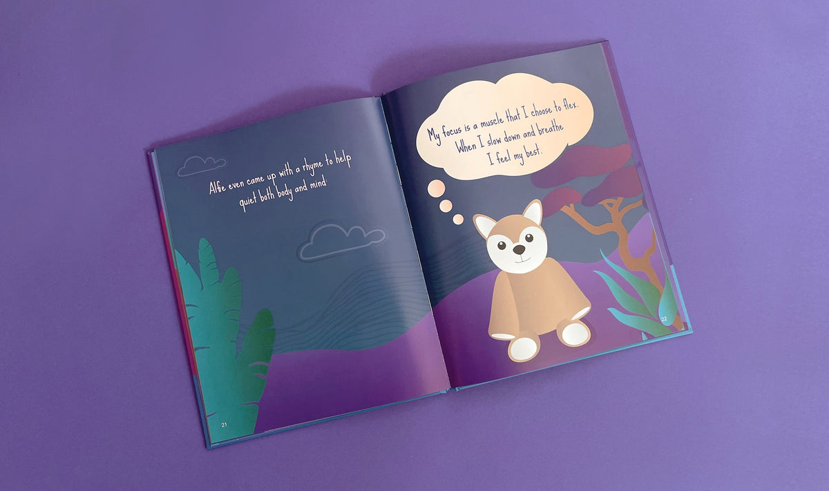 An open copy of the picture book Slow Down, Alfie! showing a cartoon dog in a thought bubble with text about mindfulness and calming tactics.