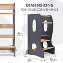 Stable Montessori Tower: Wooden Growing Chair - Grey, featuring three wooden steps and convenient cut-out handles in a grey and natural wood finish. Perfect as a kids’ kitchen helper or learning stool, this adjustable step stool measures 85 cm tall, 45 cm wide, and 38.5 cm deep. Text reads: DIMENSIONS FOR YOUR CONVENIENCE.