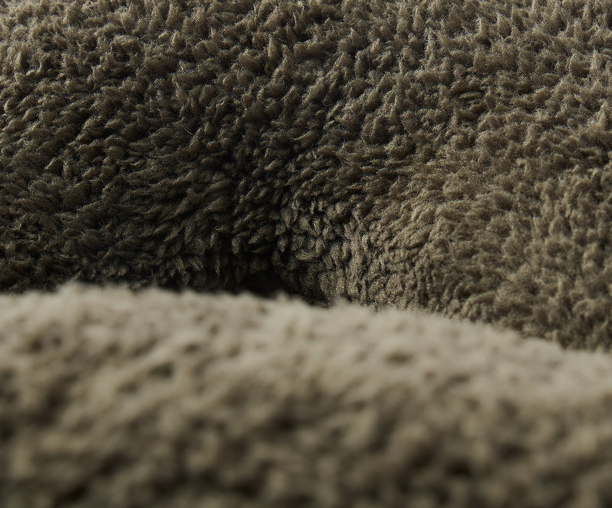 Close-up of the olive green, thick-pile textured fabric on a Gravity Weighted Neck Pillow (4 lb).