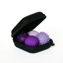 An open black zippered case holds three lavender Signets massage balls with spiked and ridged textures, designed to enhance your fidgeting experience and help improve focus.