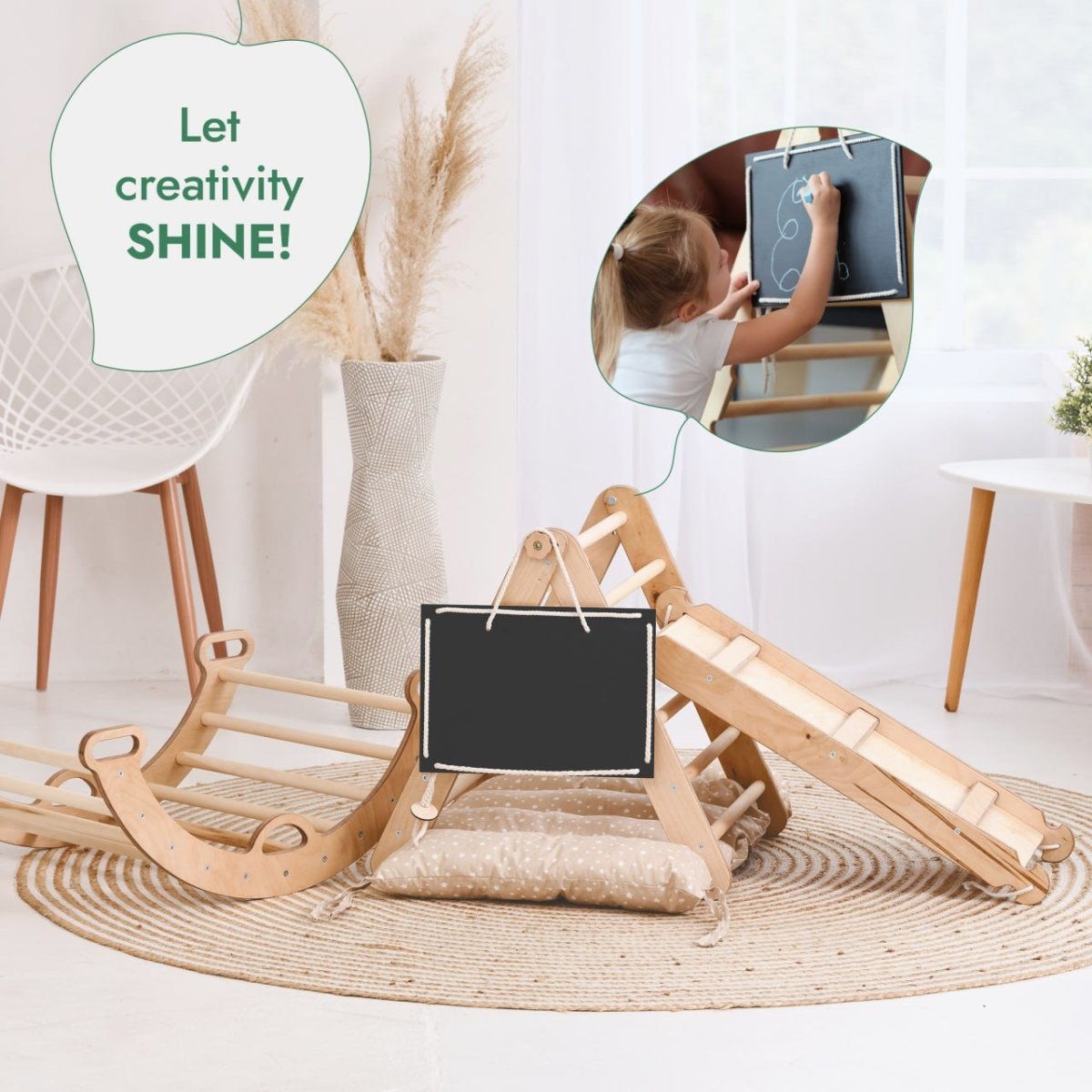 The Pikler Triangle Set for Toddlers—featuring a triangle ladder, climbing arch, slide board, and cushion—sits on a round rug in a bright room. An inset shows a child drawing on the chalkboard. Text reads: Let creativity SHINE!.