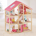 The Tiny Land® Sweetwood Love Dollhouse without Dolls features a pink roof, several rooms, beds, chairs, tables, and stairs—perfect for imaginative play. Displayed on a light carpeted floor in a bright room.
