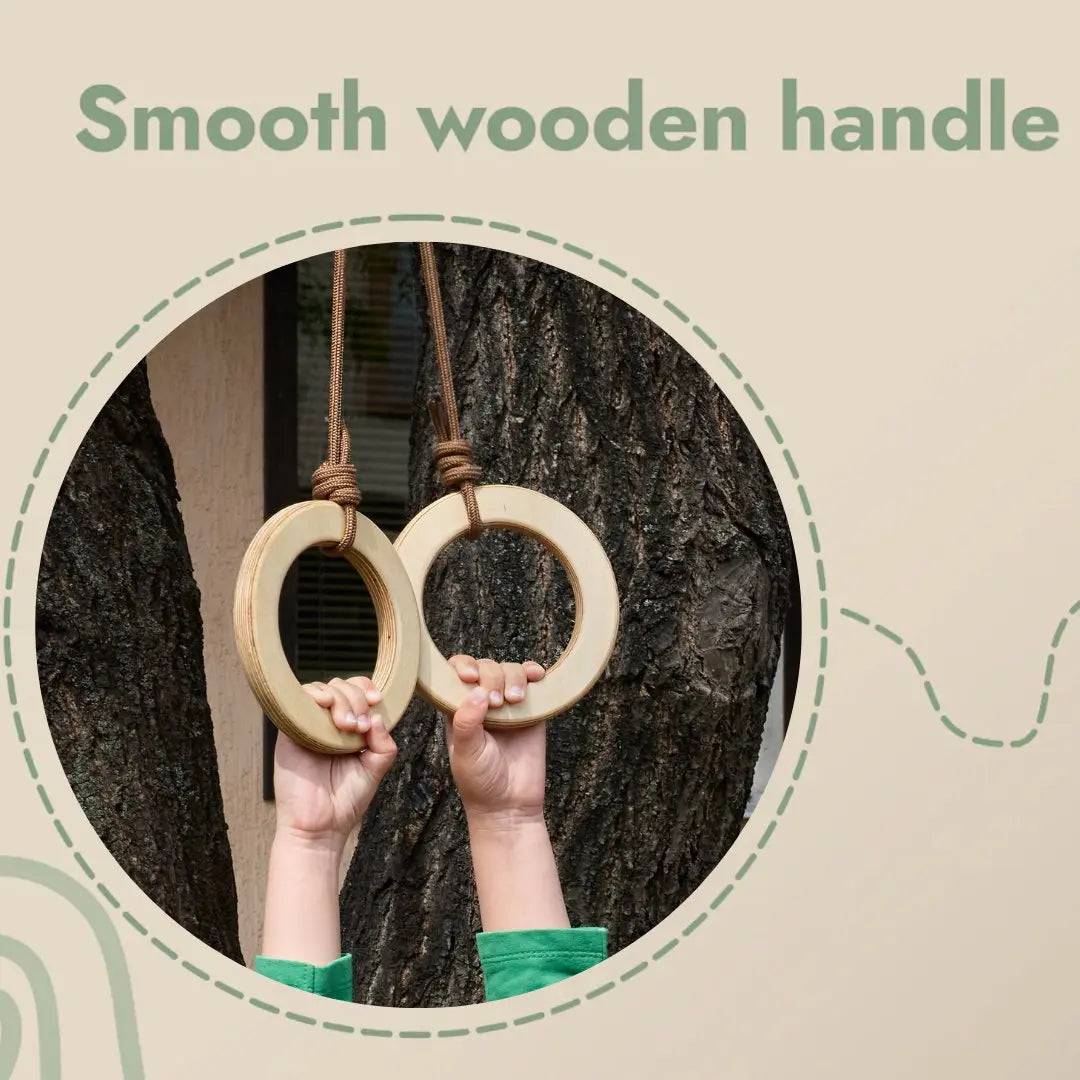 Two children’s hands hold the Wooden gymnastic rings for kids, their smooth wooden handles hanging securely by ropes from a tree. The text Smooth wooden handle appears above the image—an inviting scene that promotes children’s physical development and fitness.